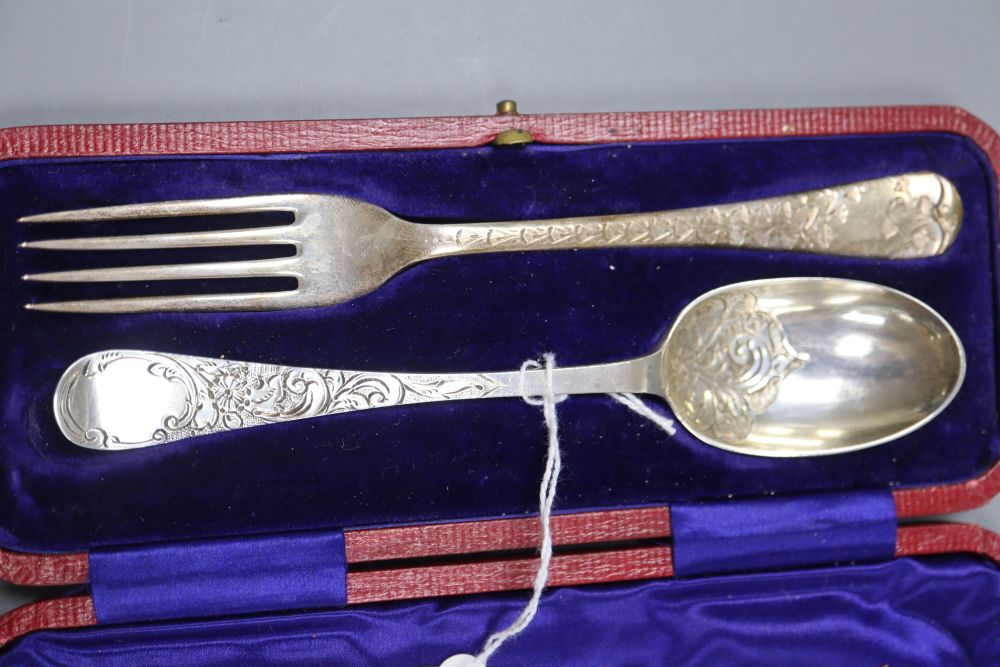 A pair of George V silver wine labels and cased Edwardian silver christening pair.
